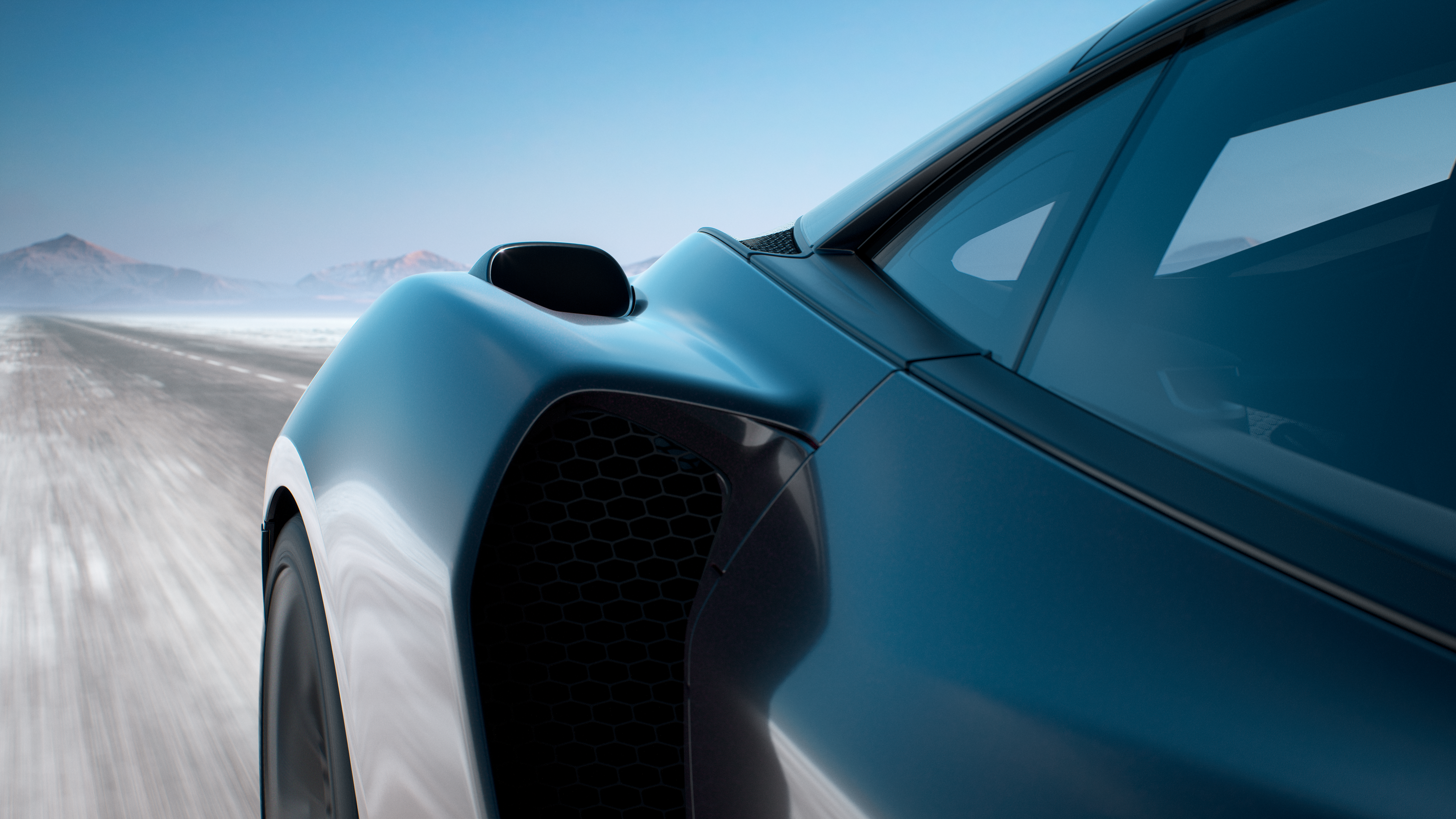  A close-up, low-angle shot of the rear side of a dark McLaren car, highlighting its sleek body, side air intake with a honeycomb grille, and a blurred snowy road suggesting motion.