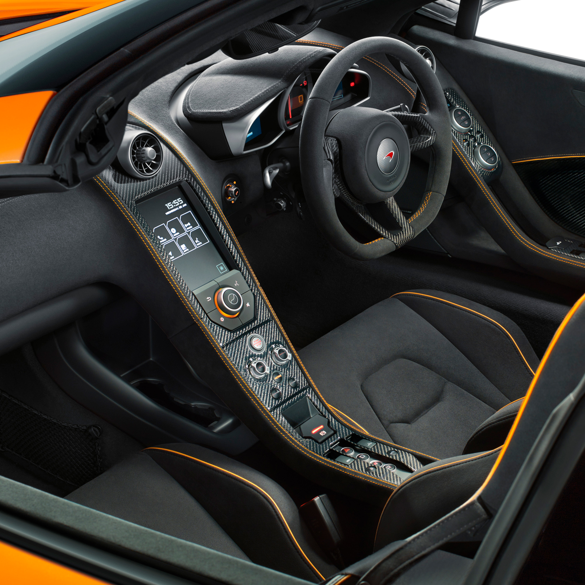 The interior of an orange McLaren 650S Spider, photographed in a bright white studio environment.