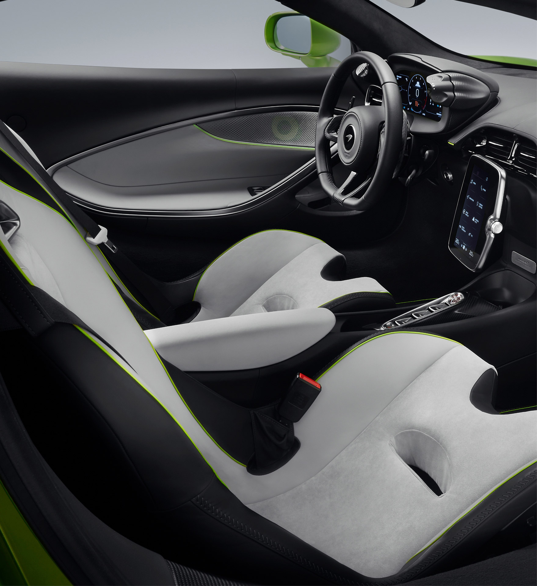 McLaren Artura autocar interior in black and white with green detailing.