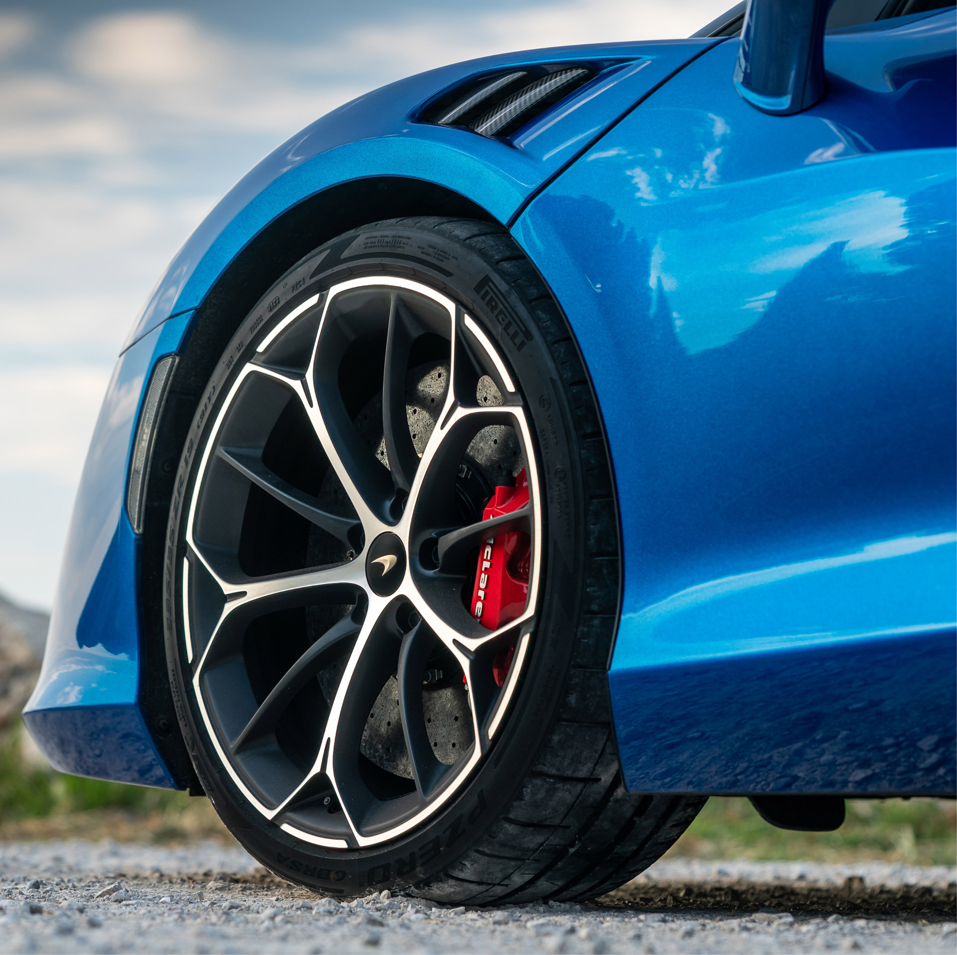 Close up of McLaren Artura wheel with red break caliper.