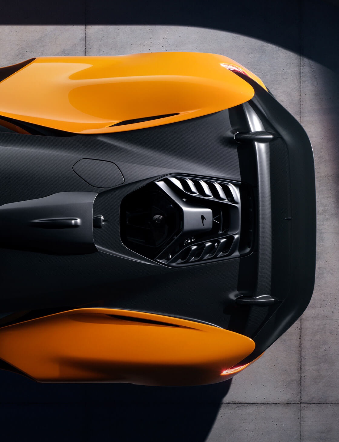 A well rendered and detailed top profile view of only the back half of an orange and black McLaren W1.