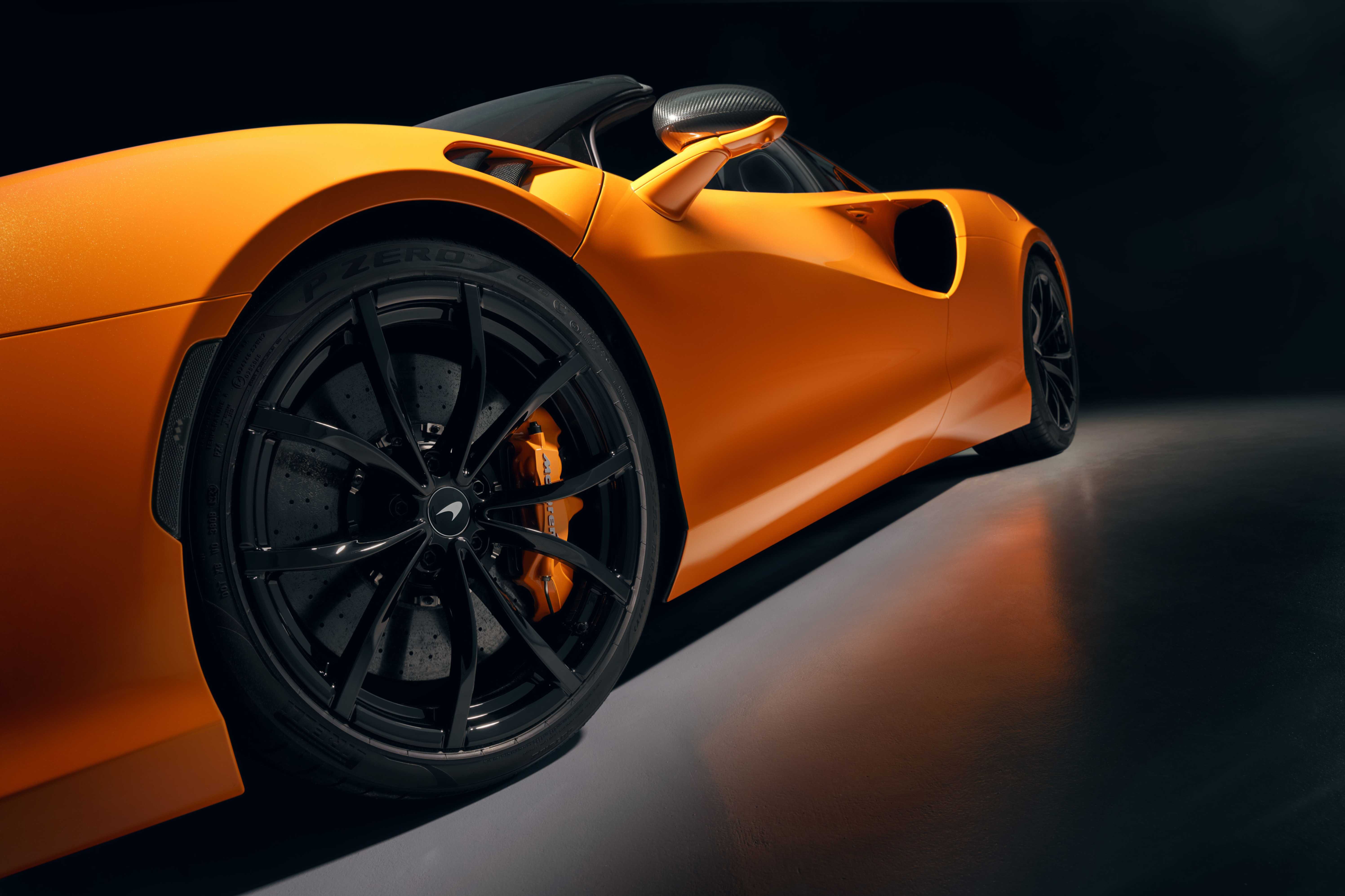 Close up of McLaren Artura Spider wheel with orange caliper. 