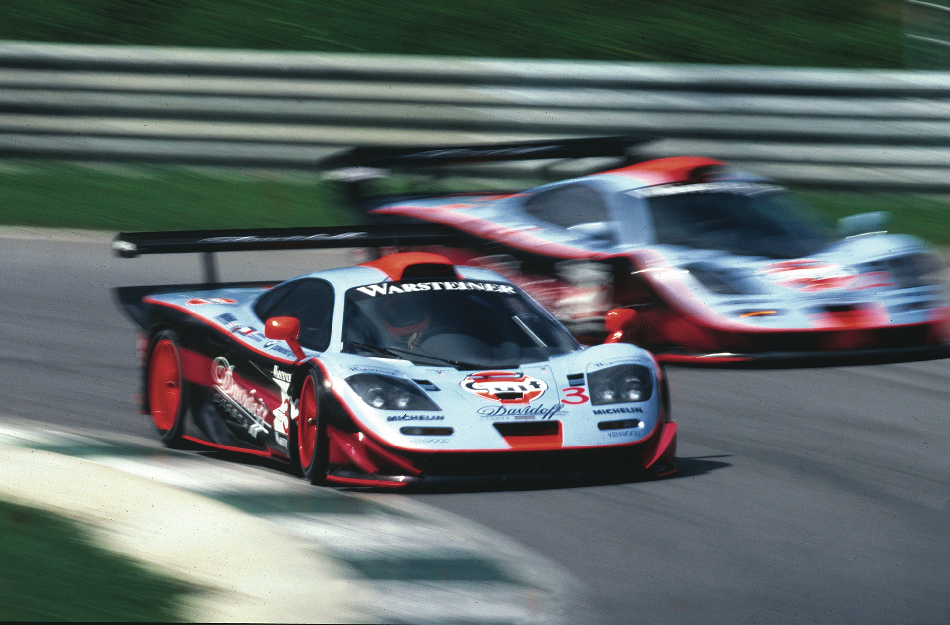 Historic McLaren F1 GTR Longtail race cars on track, celebrating LT legacy and motorsport inspiration