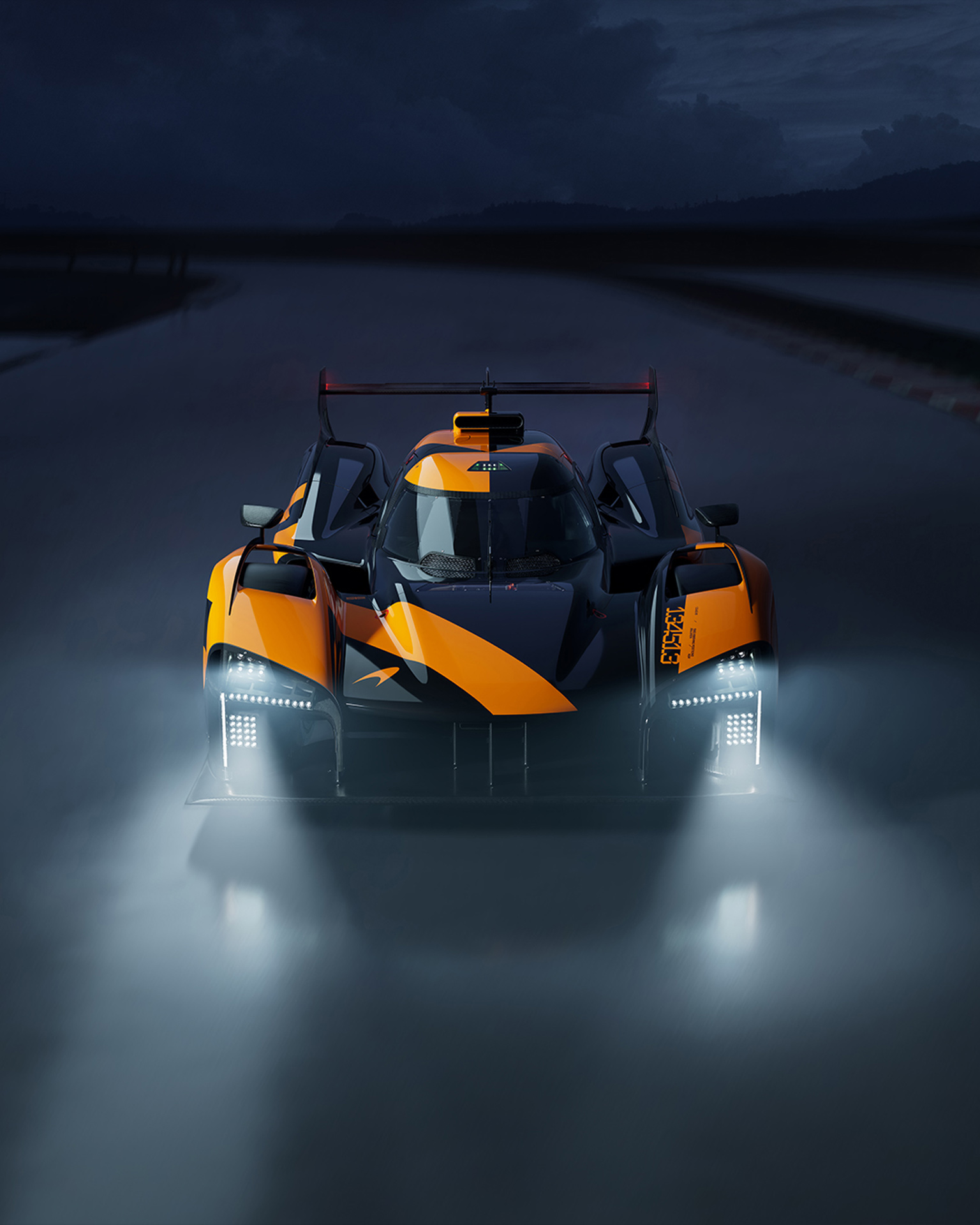 The McLaren Project Endurance concept race car shown at night with bright headlights, highlighting its aggressive aerodynamic design.
