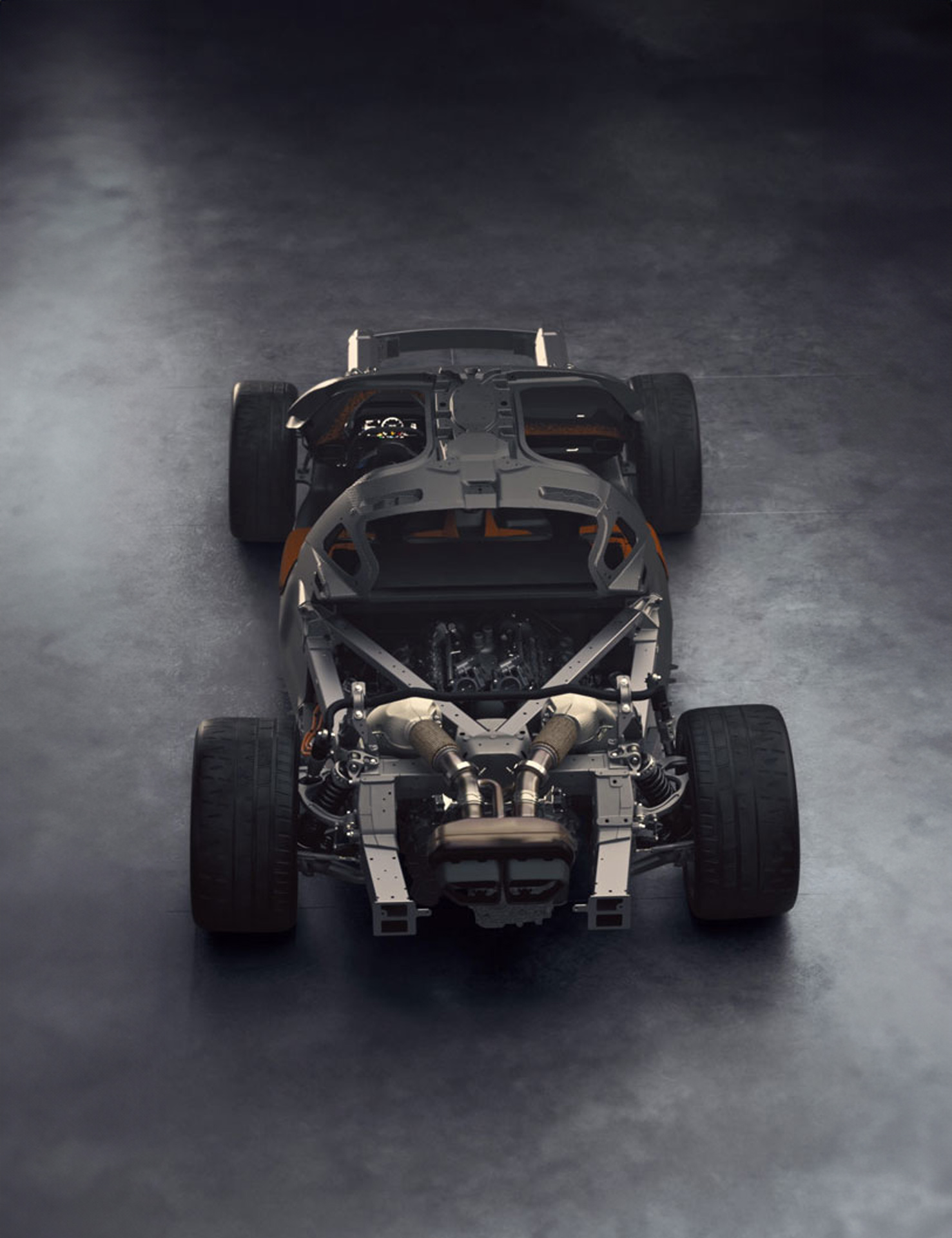 An overhead view of a McLaren W1 chassis, with the body removed to highlight its lightweight engineering and exposed engine.