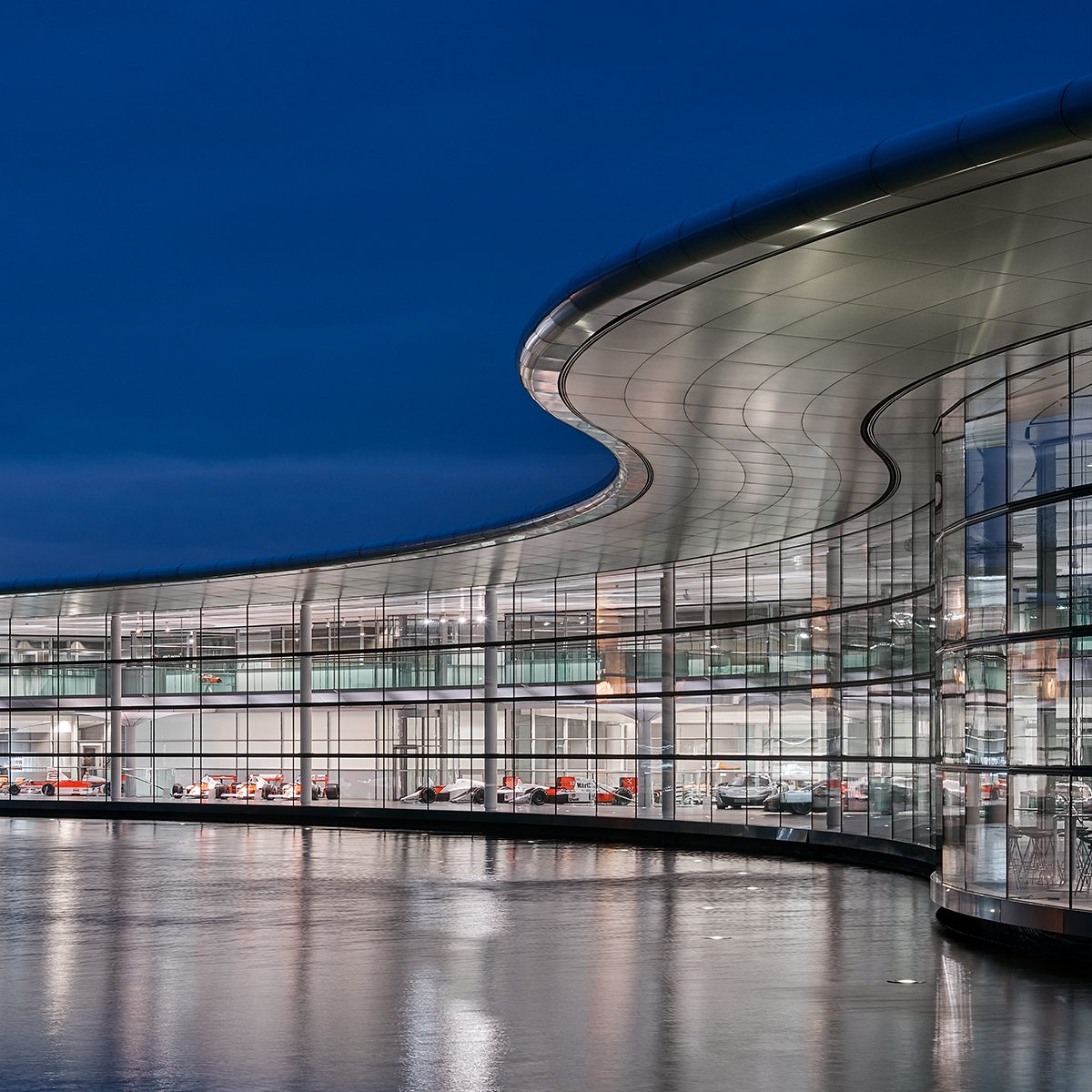McLaren Technology Centre lit up at night, on the waterfront.