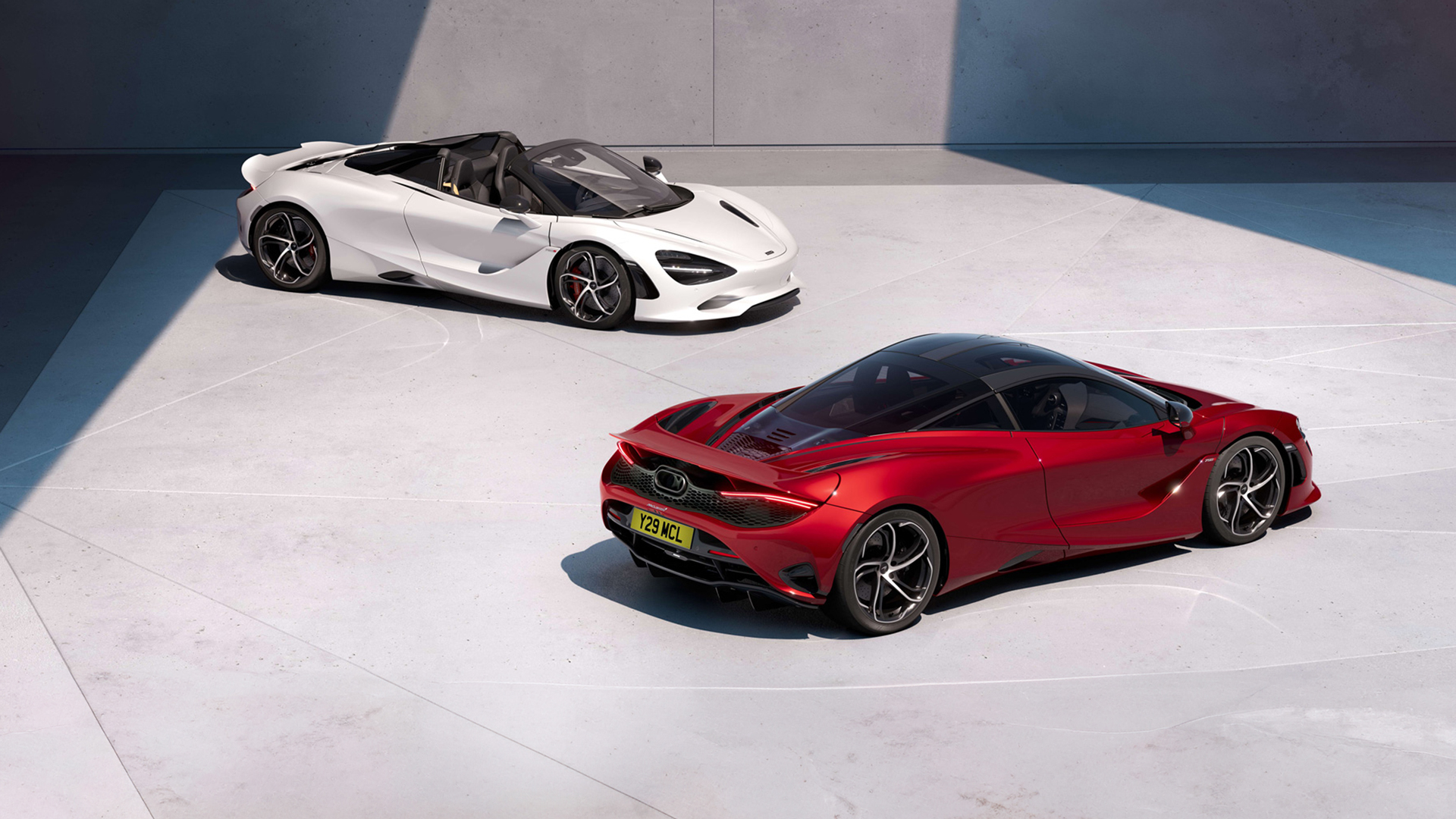 Two iconic McLaren 750S supercars representing the pinnacle of lightweight performance. A vibrant red 750S Coupe is parked alongside a dazzling white 750S Spider convertible, showcasing the twin-turbo V8 sports series lineage and ultimate driving precision.