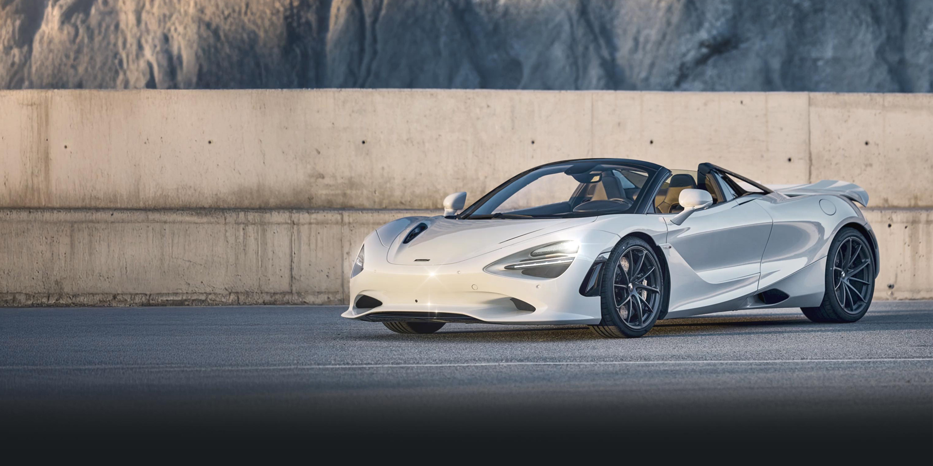 White Mclaren 750S Spider parked on a mountain road.