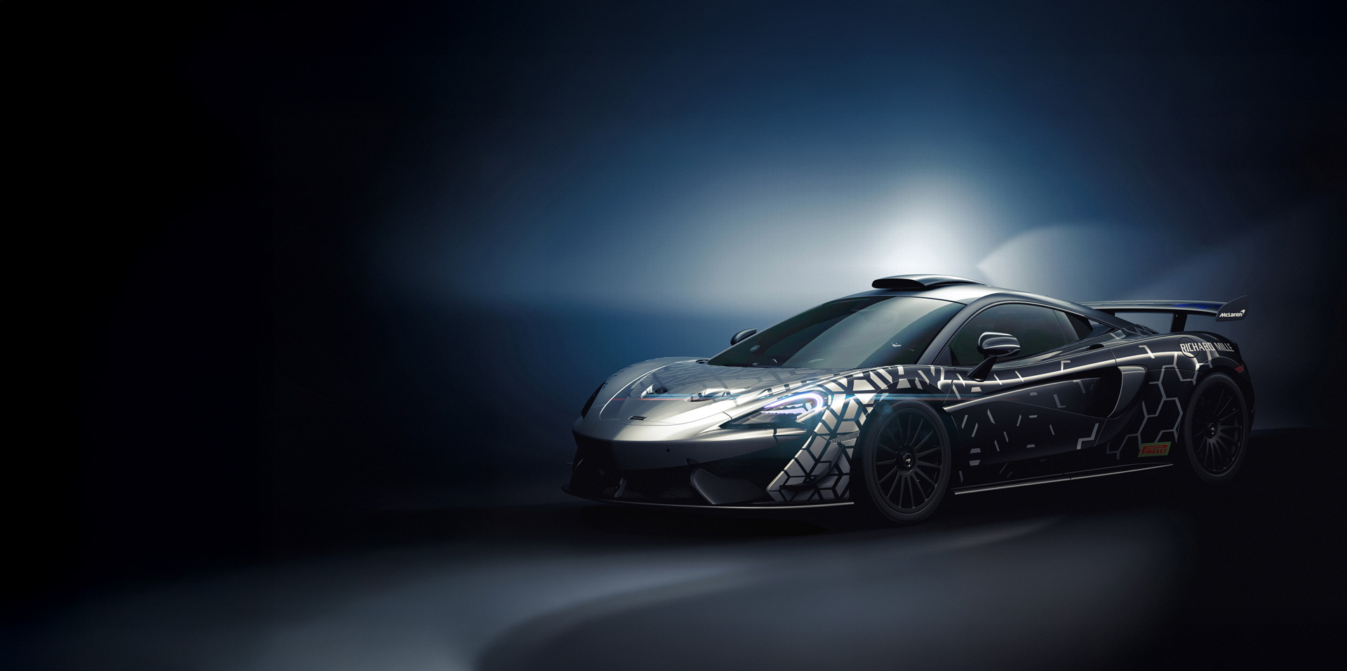 McLaren 620R photographed in a dark studio environment, with light rays and diffractions bouncing off the body.