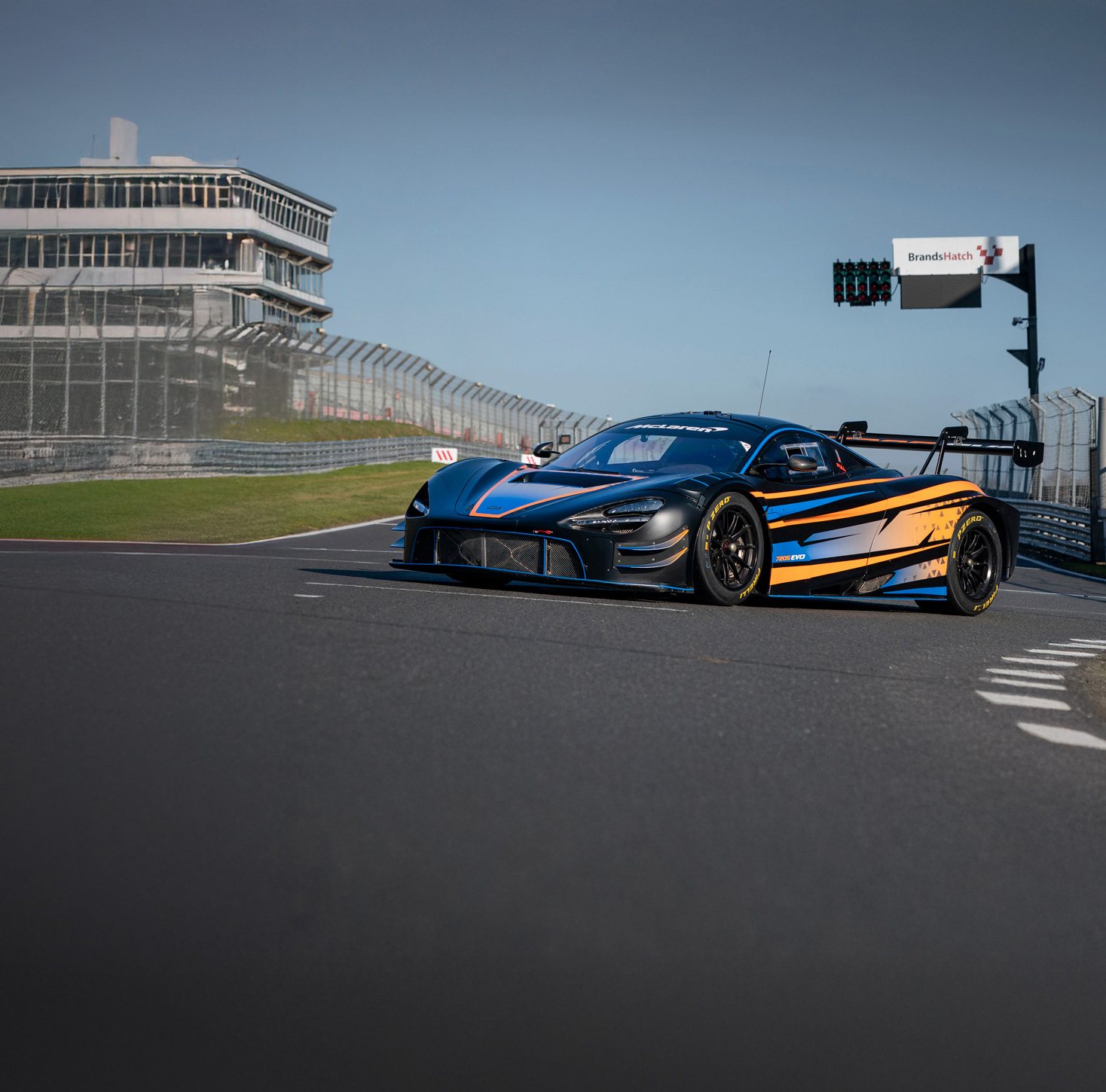 The McLaren 720S GT3 EVO parked on a race track. 