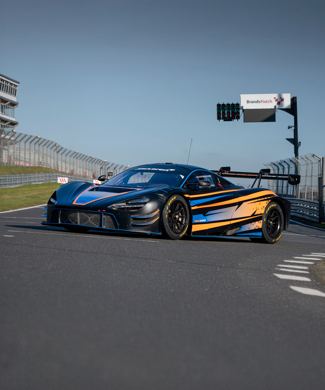 The McLaren 720S GT3 EVO parked on a race track. 