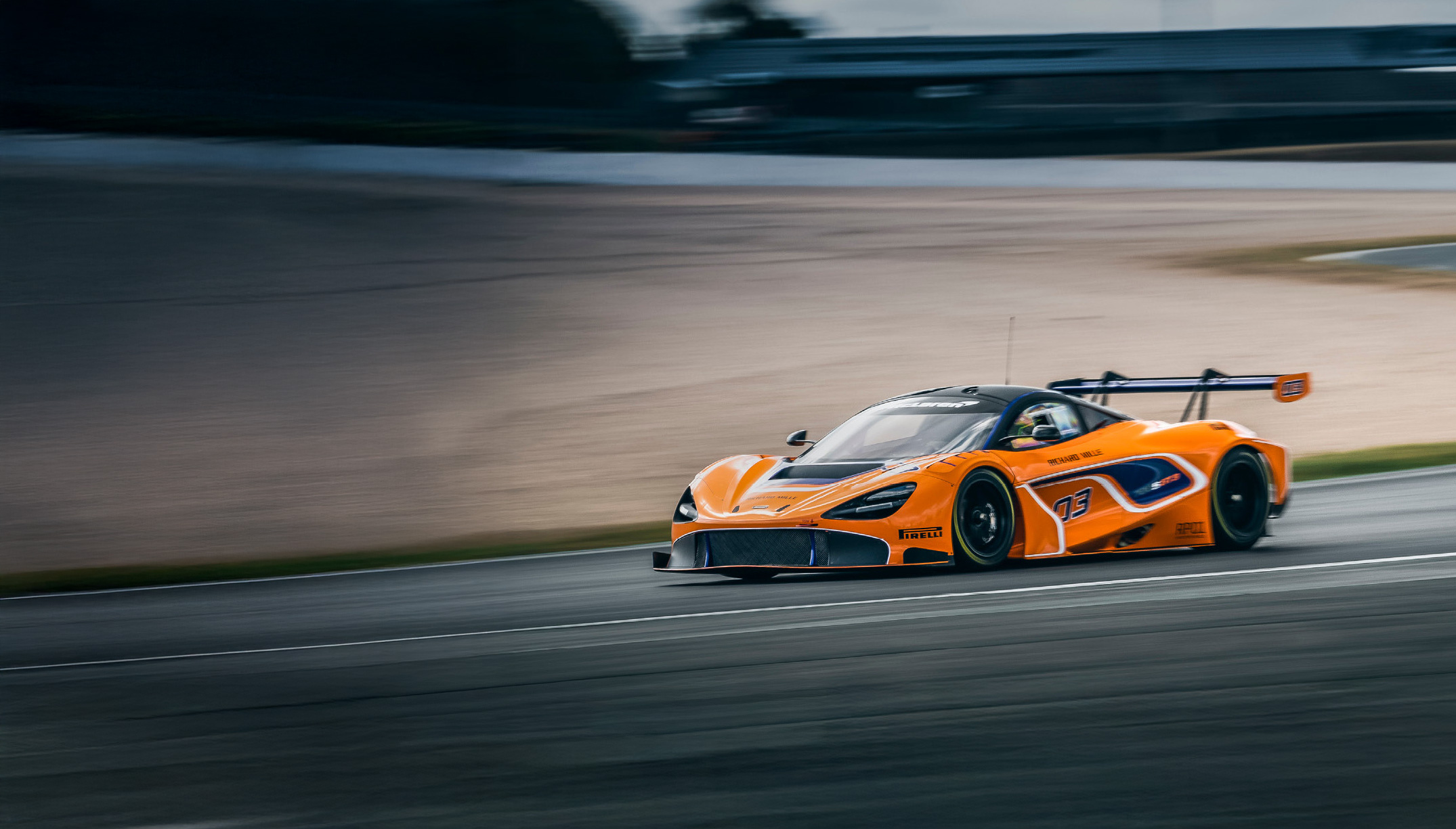 McLaren 720S GT3 driving on a track at speed.
