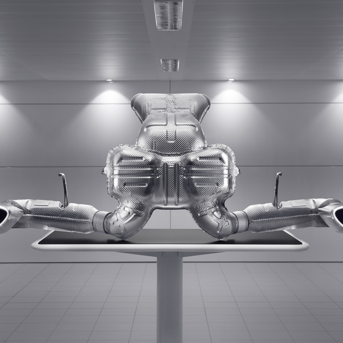  A detailed, symmetrical studio shot of a McLaren performance exhaust system