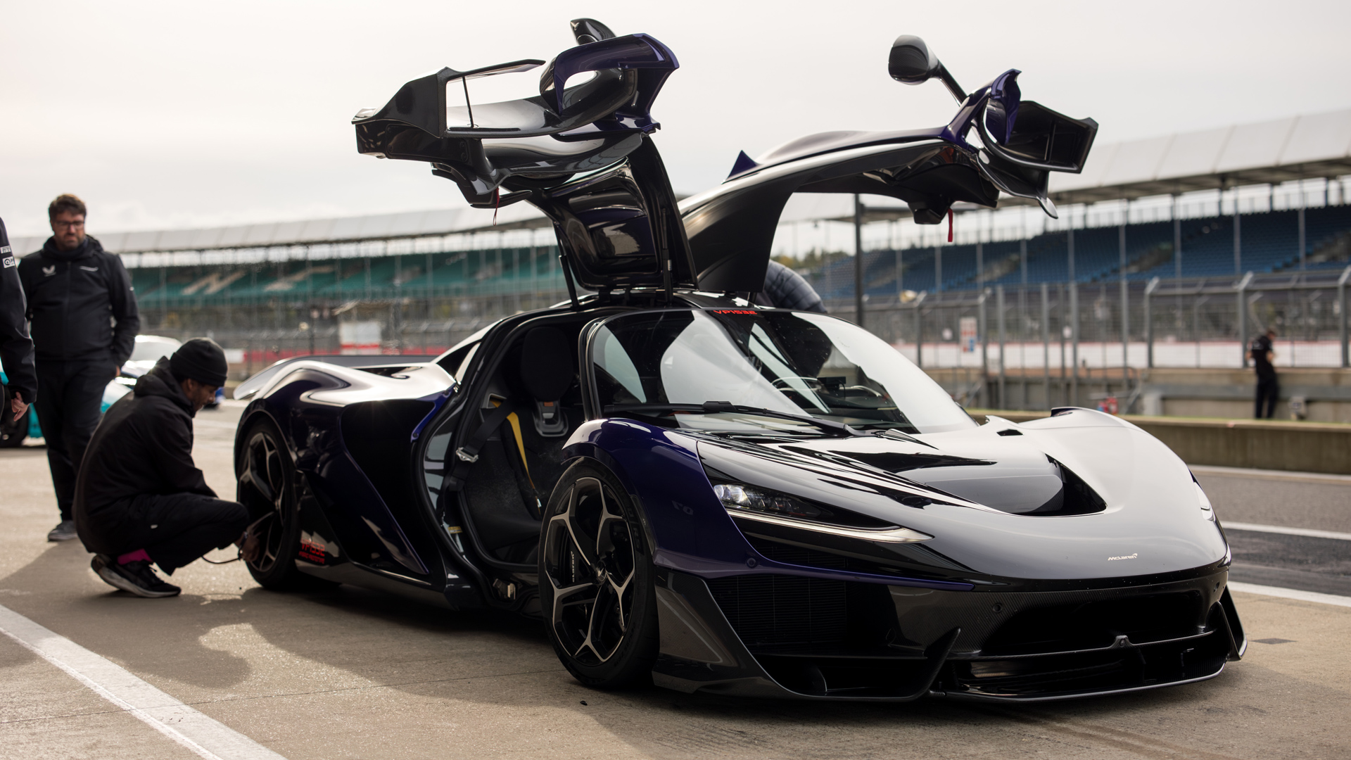 The McLaren W1 prototype parked in the Silverstone pit lane with it's McLaren Anhedral doors with integrated aero blades open.