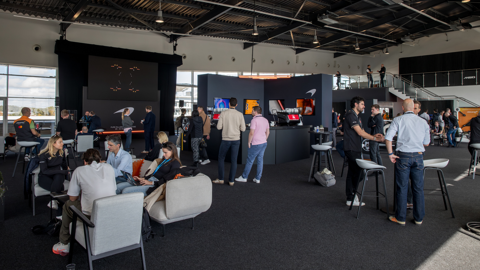 McLaren Silverstone Experience participants waiting within the designated McLaren hospitality room.
