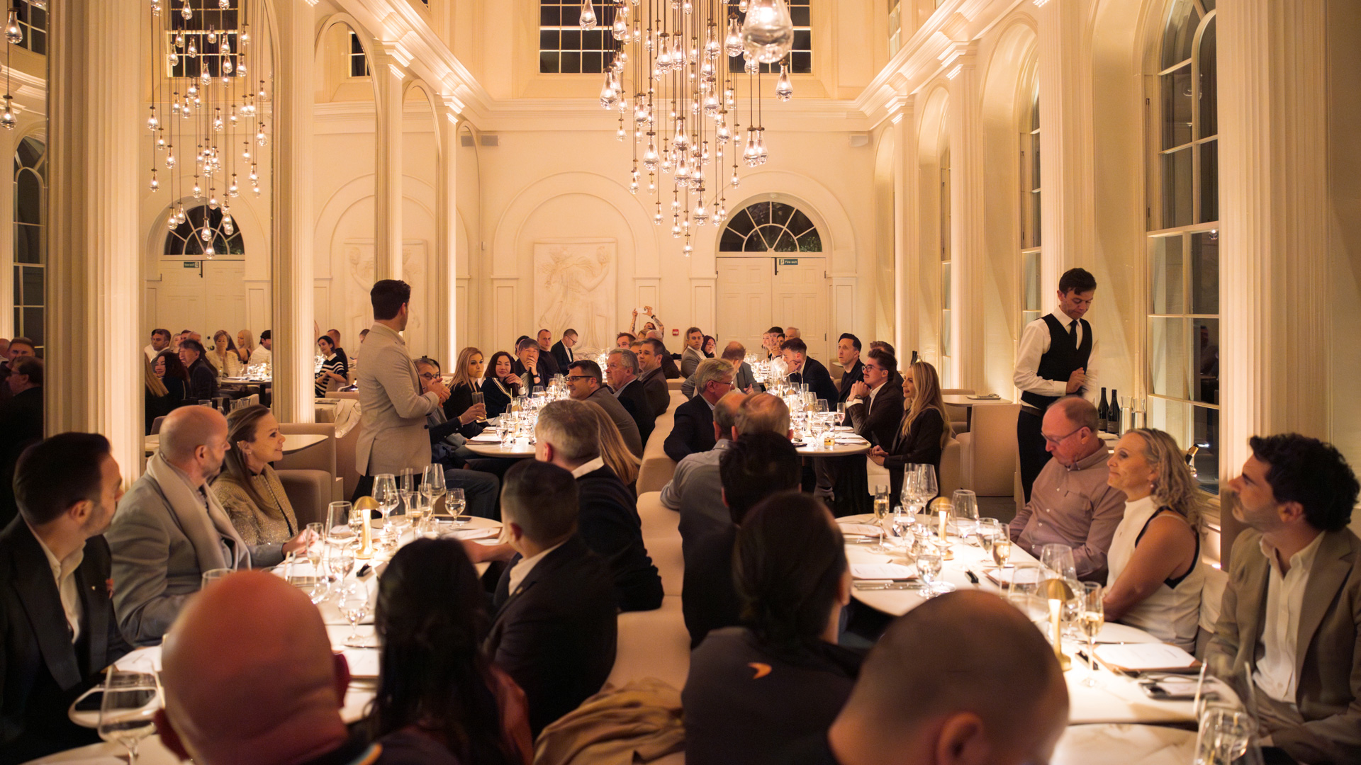 McLaren Silverstone experience participants sat having a luxury meal.