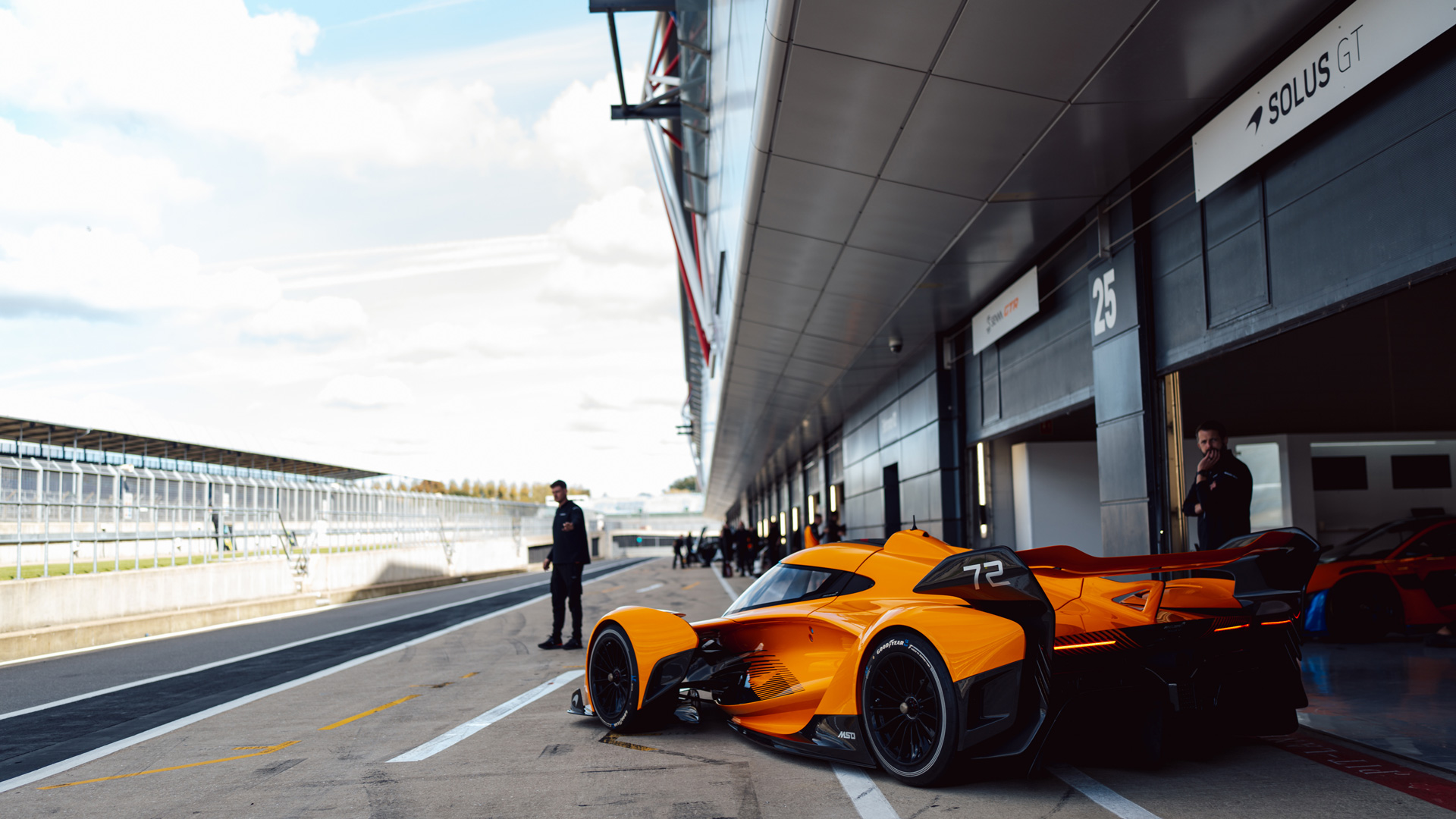 A rear three quarter shot of the McLaren Solus GT parked within the pit lane of the Silverstone race track.