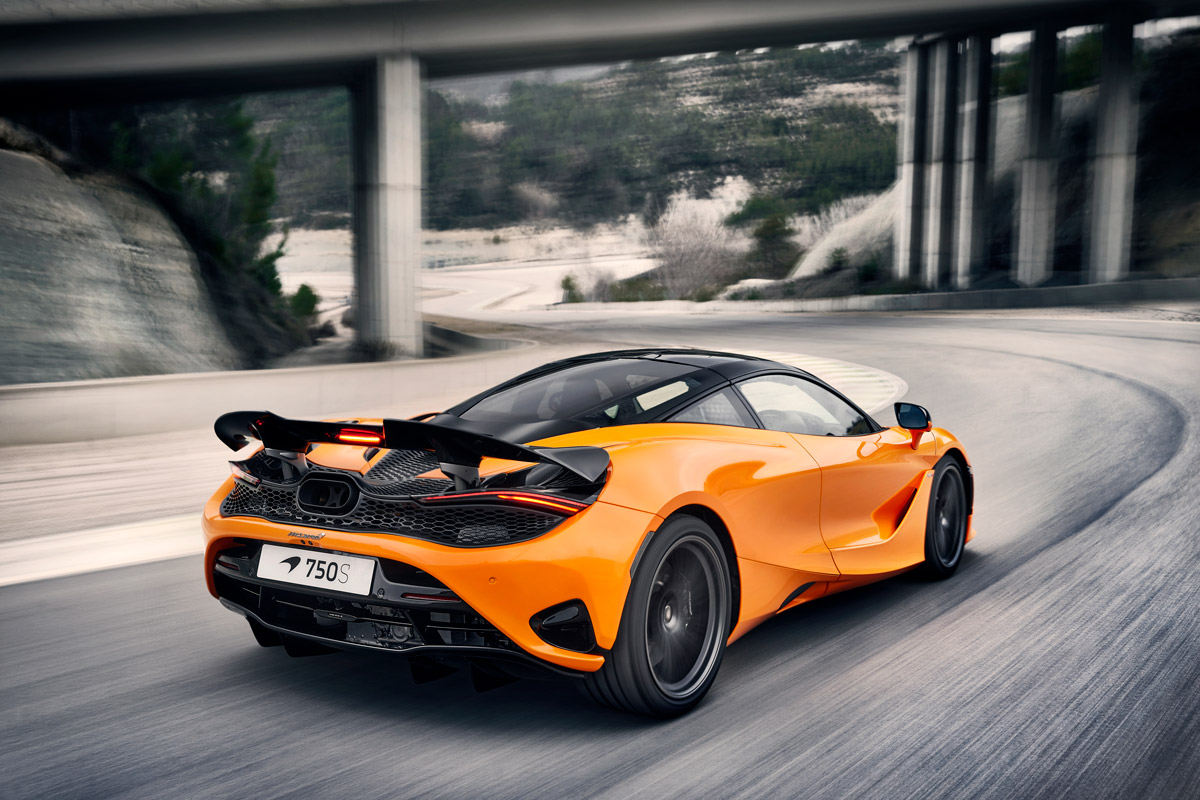 McLaren 750s rear view, driving under a bridge at speed.