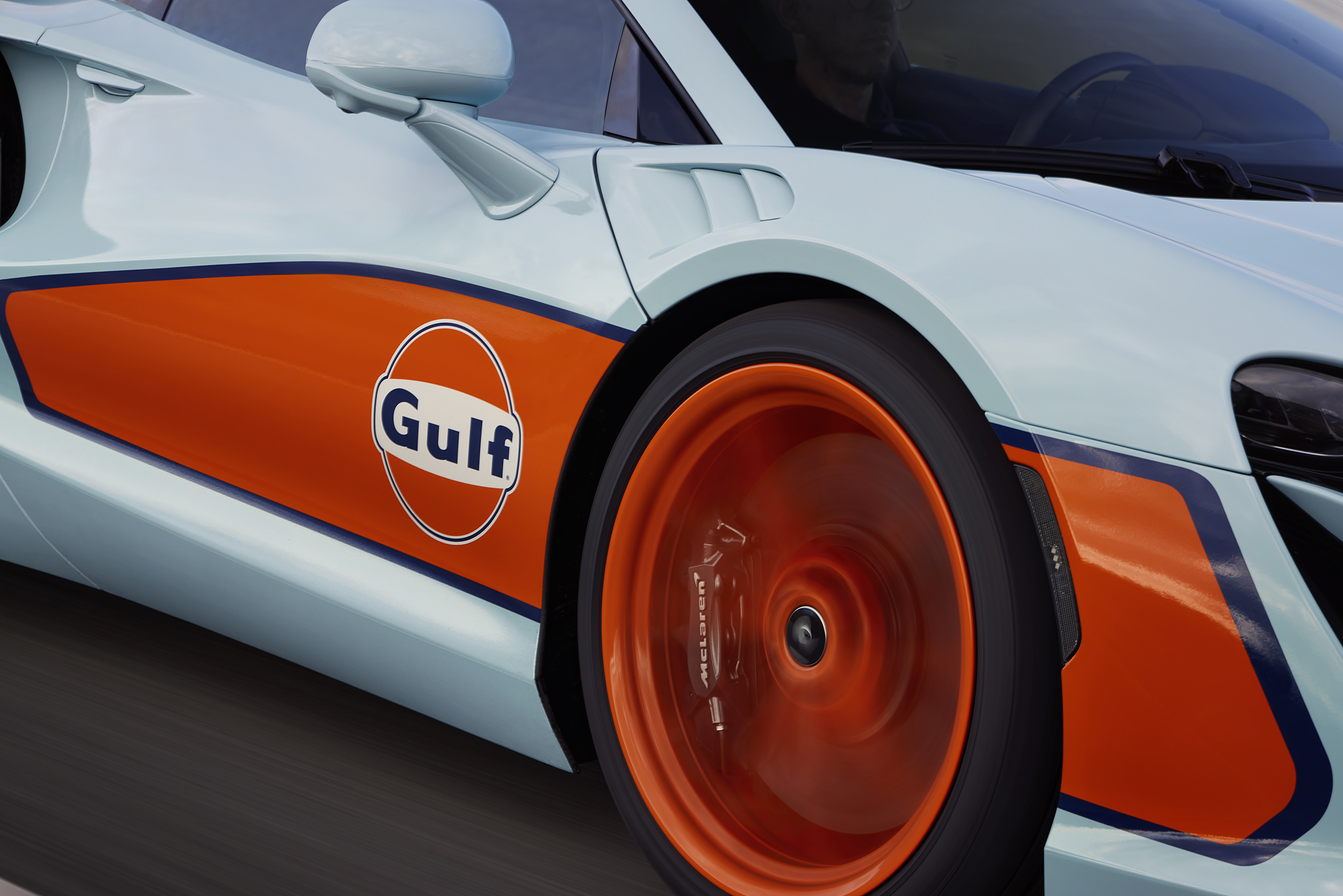 Close up of the drivers side wheel  and logo on the Gulf branded McLaren.