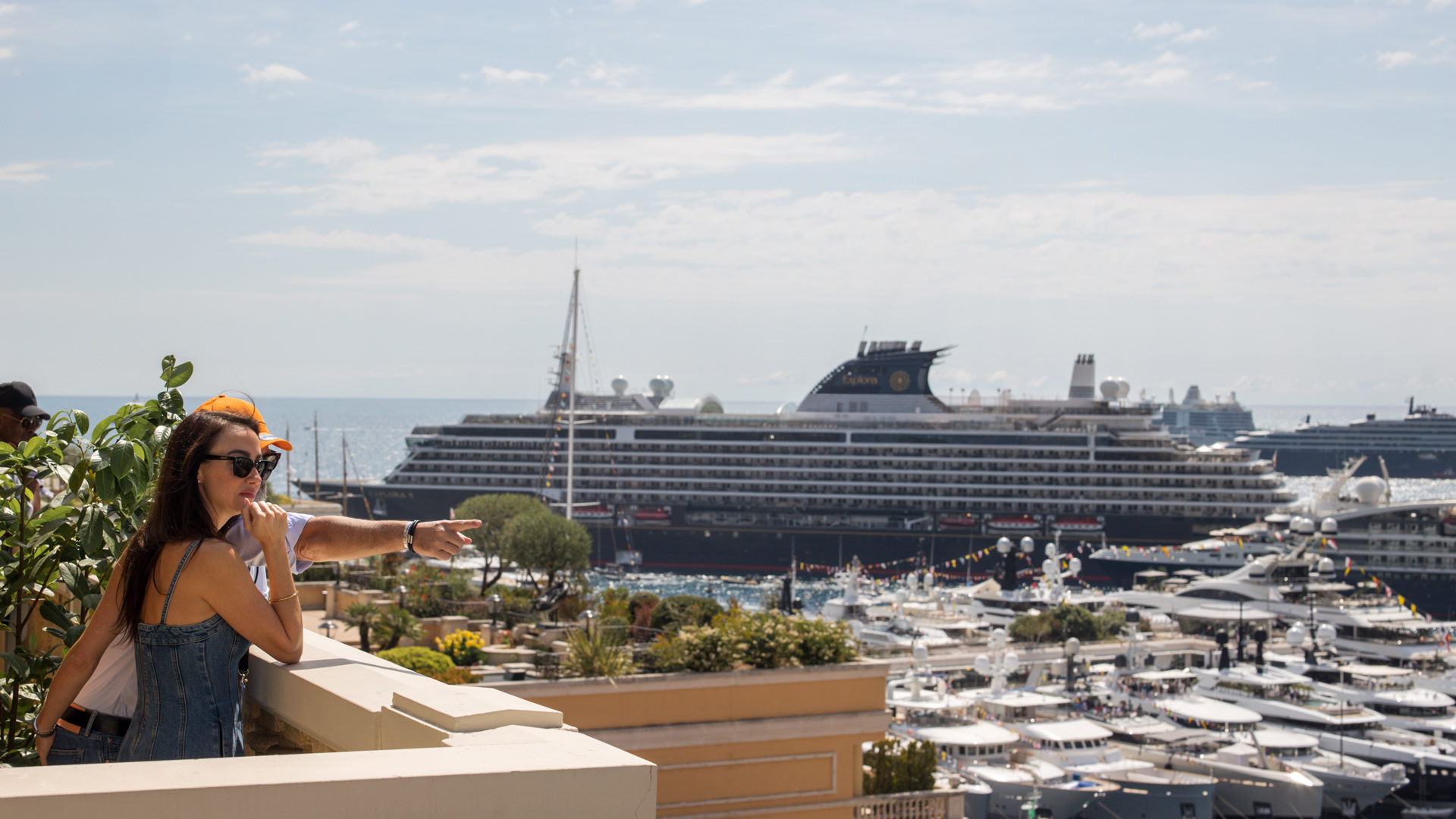 Guests enjoying the stunning panoramic view of the Monaco harbor, full of luxury yachts and cruise ships, as part of a McLaren experiences package during the Grand Prix.