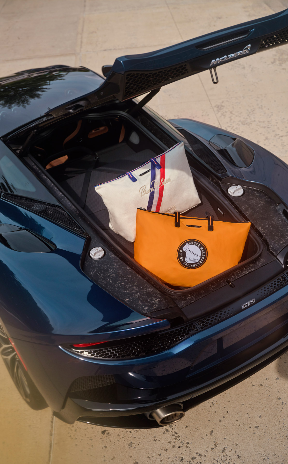 TUMI | McLaren tote bags sat in the trunk of a McLaren GTS.