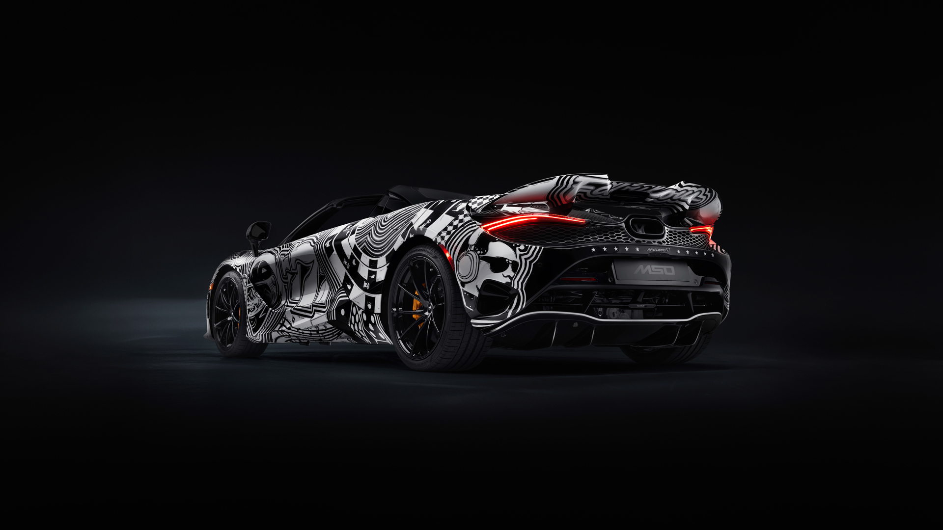 Rear three-quarter view of the bespoke McLaren 750S Spider Project Viva by MSO, showcasing the unique rear deck and custom hand-painted black-and-white livery.