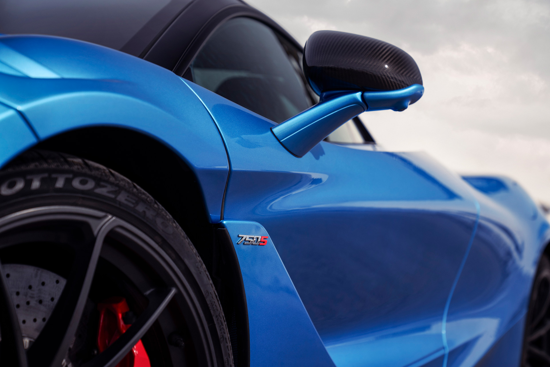 Close up for McLaren 750S badge on the side of a blue McLaren 750S.