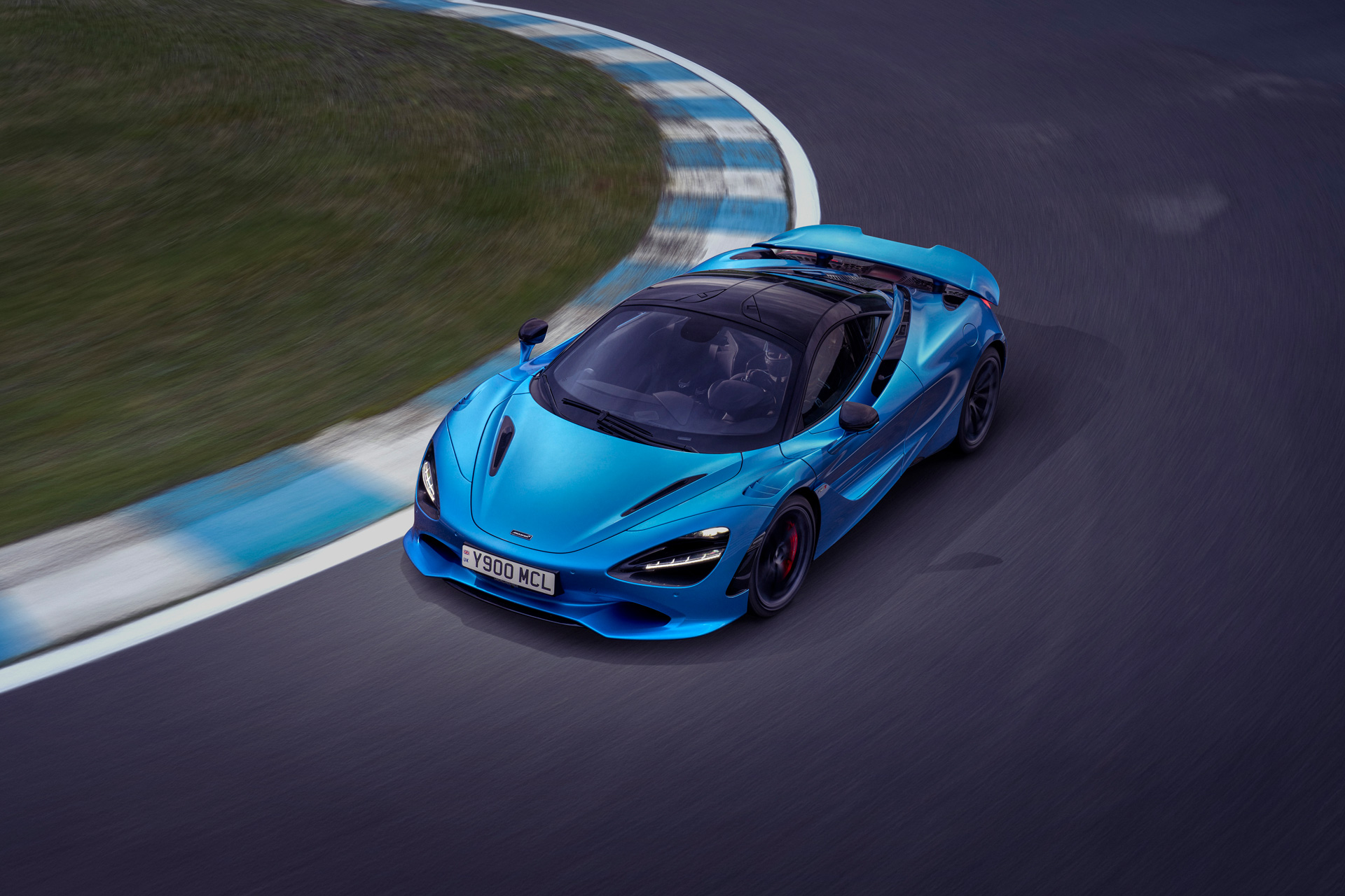 Blue McLaren 750S driving around a race track at speed. 